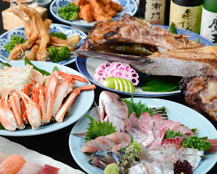 A course spread of crab, grilled fish and sashimi