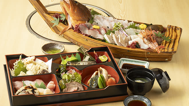 A funamori sashimi boat with individual meal trays