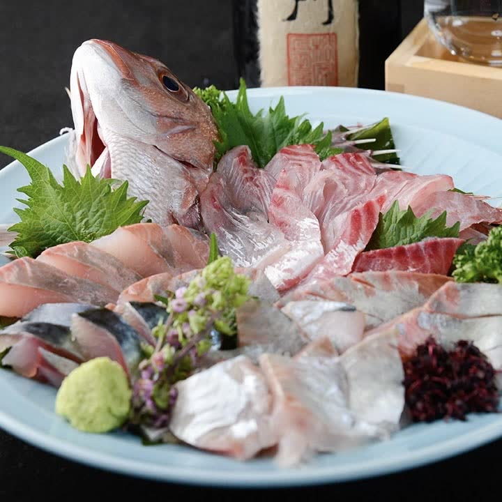 Assorted sashimi centred on a whole sea bream, with the day's fish