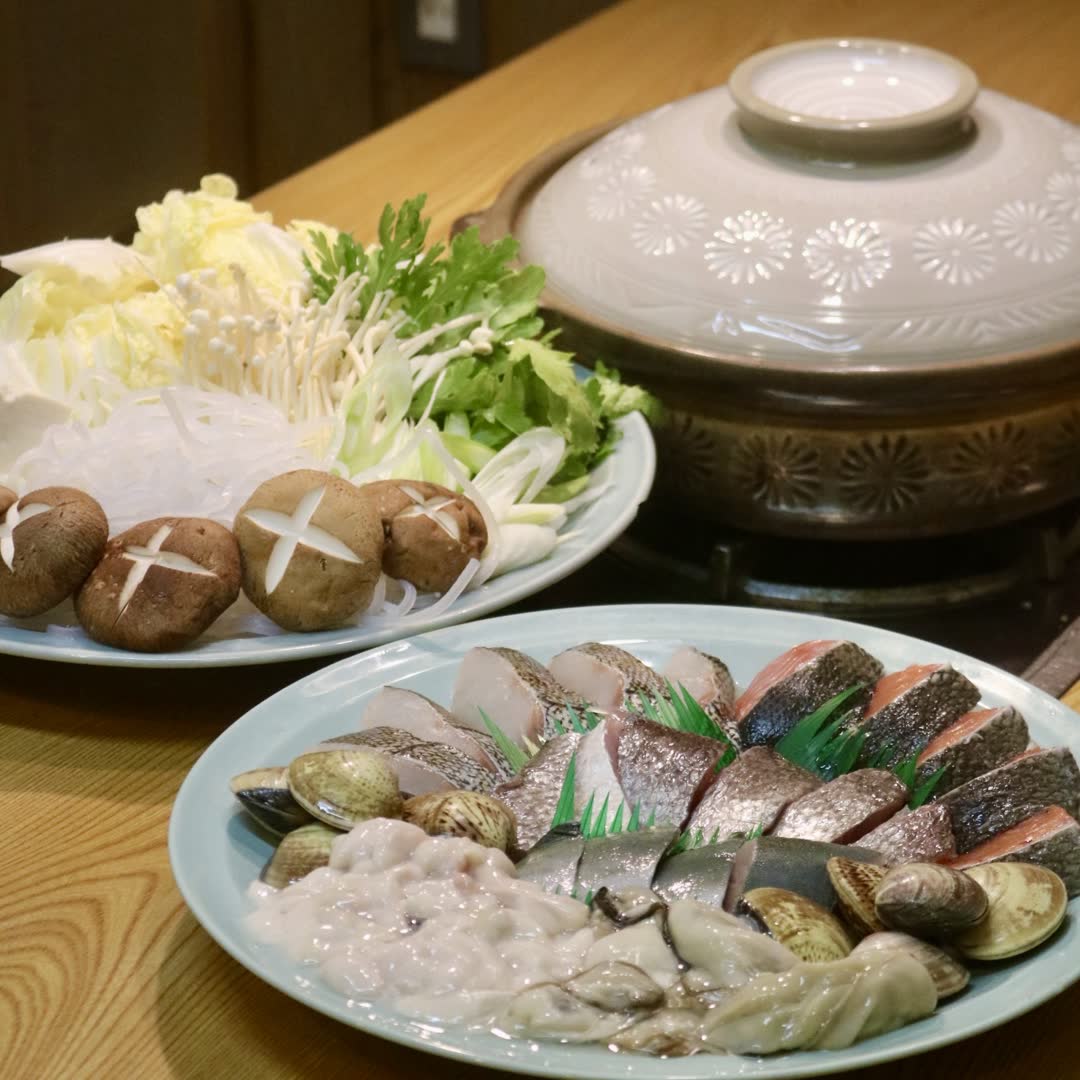 A hotpot being prepared with pike conger and shellfish in season