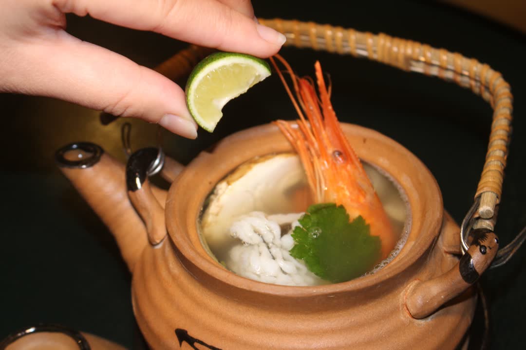 Dobin-mushi: a clay teapot broth with prawn and mitsuba, served with sudachi