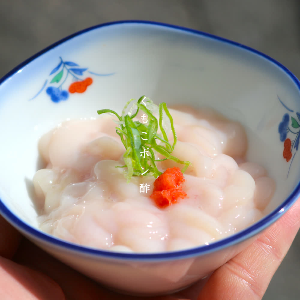 Blanched pufferfish served with ponzu and chopped spring onion